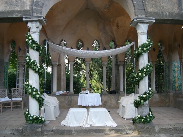 In Ashkenazi ceremonies those under the chuppah stand, but in Sephardi weddings, everyone under the canopy sits. The chuppah has to be large enought to accomodate the chairs. The chairs for the bride and groom are put aside until they arrive under the canopy, when they are placed in position by two groomsmen.